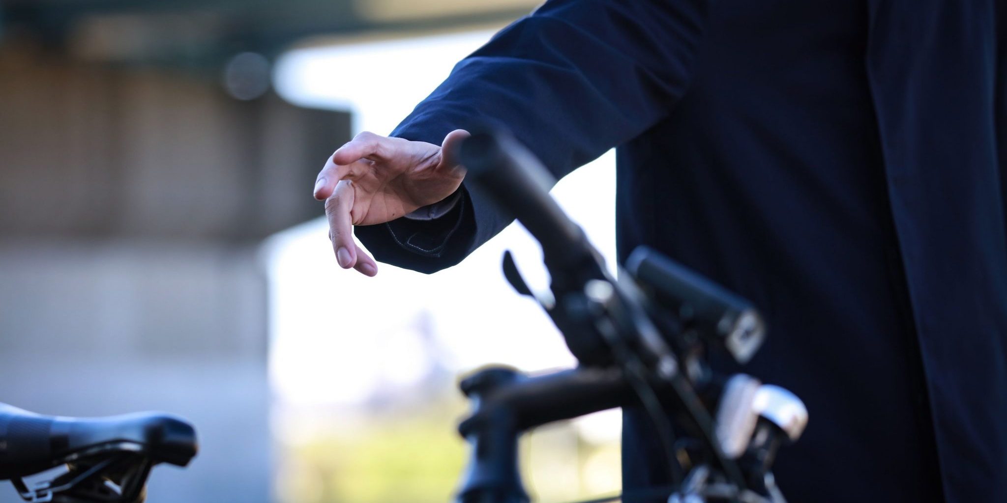 Mann in schwarzer Kleidung greift nach Fahrrad